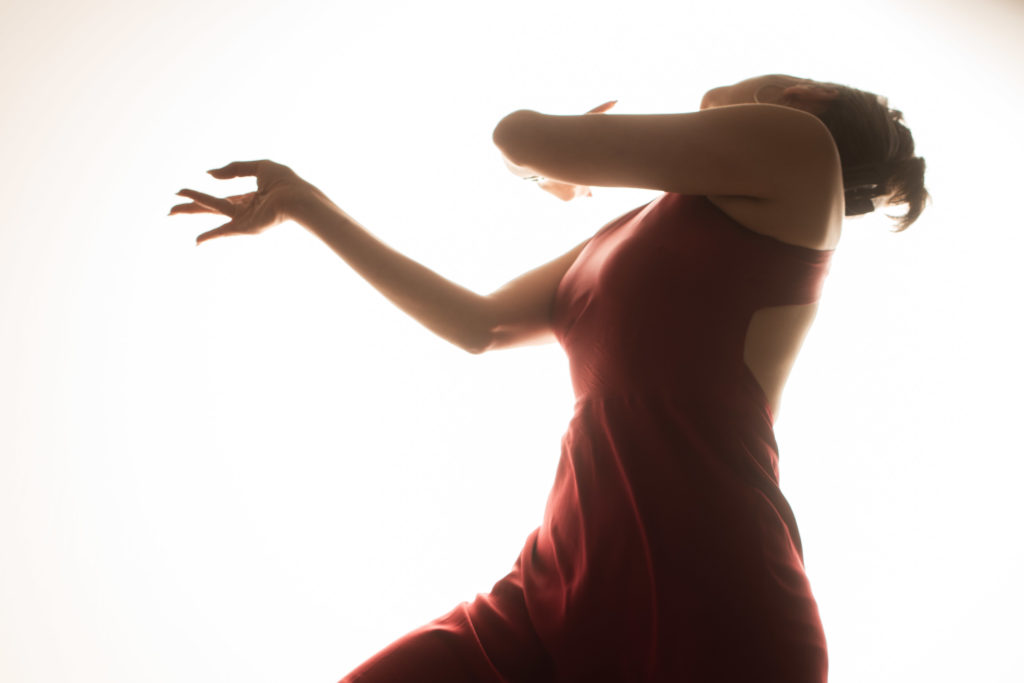 Leyya Mona Tawil dancing in a red dress