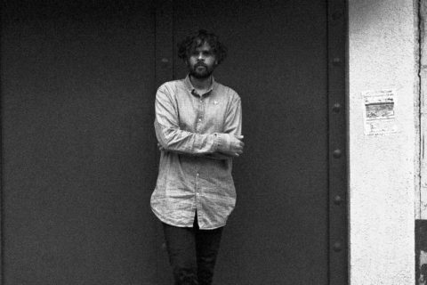 Black and white photo of Diego Aguirre Fernández leaning against a wall